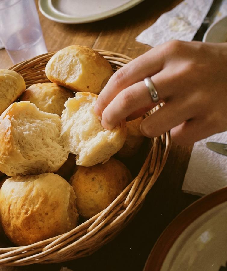A golden bun torn open to show the soft center